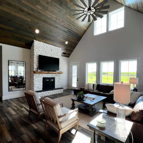 A sitting area with a high ceiling and large windows